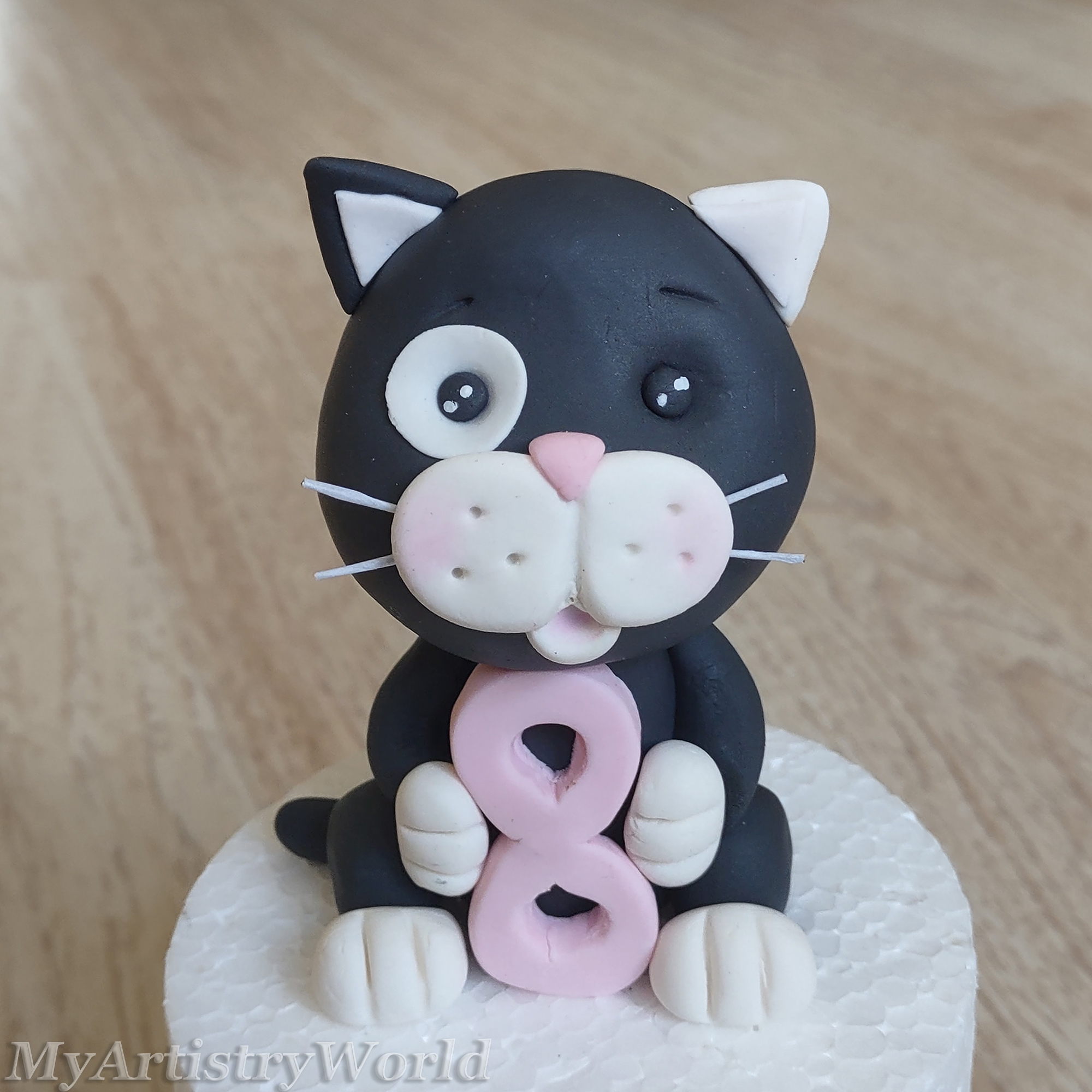 Cat with a number cake topper