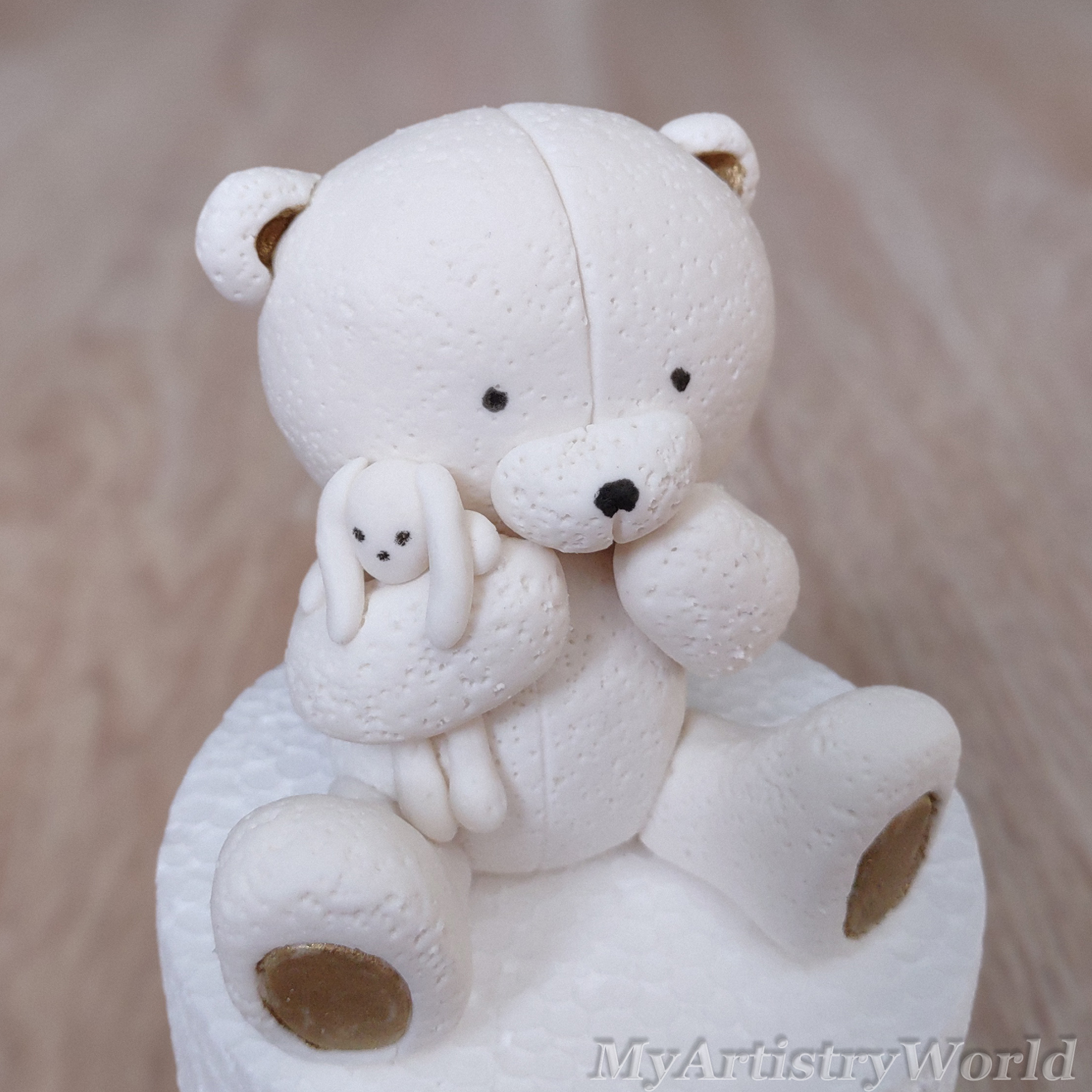 Bear holding a toy bunny cake topper