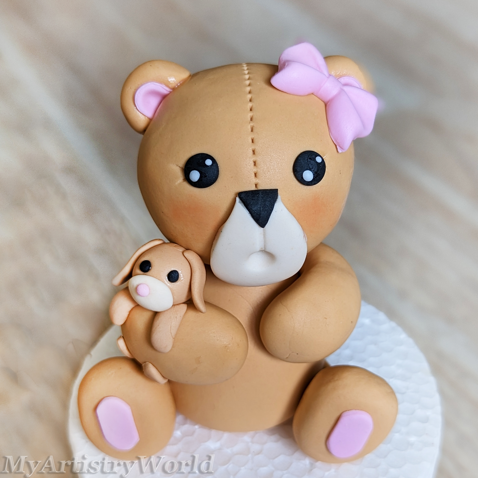 Bear holding a toy bunny cake topper