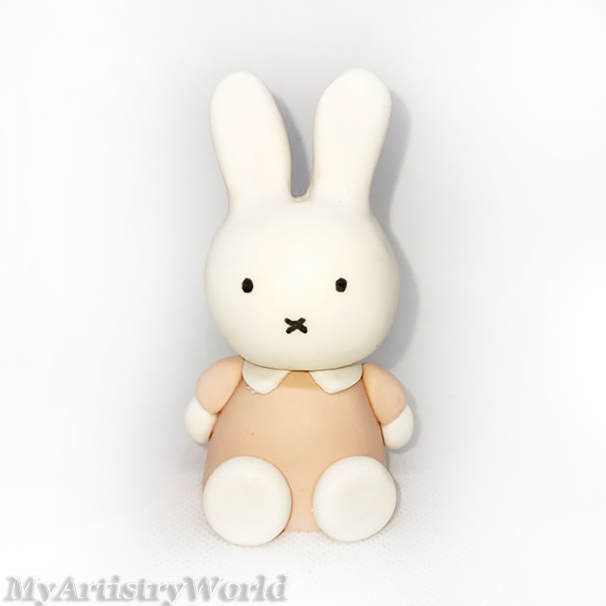 Handmade edible Miffy bunny cake topper sitting with a balloon for birthday and baby shower cakes