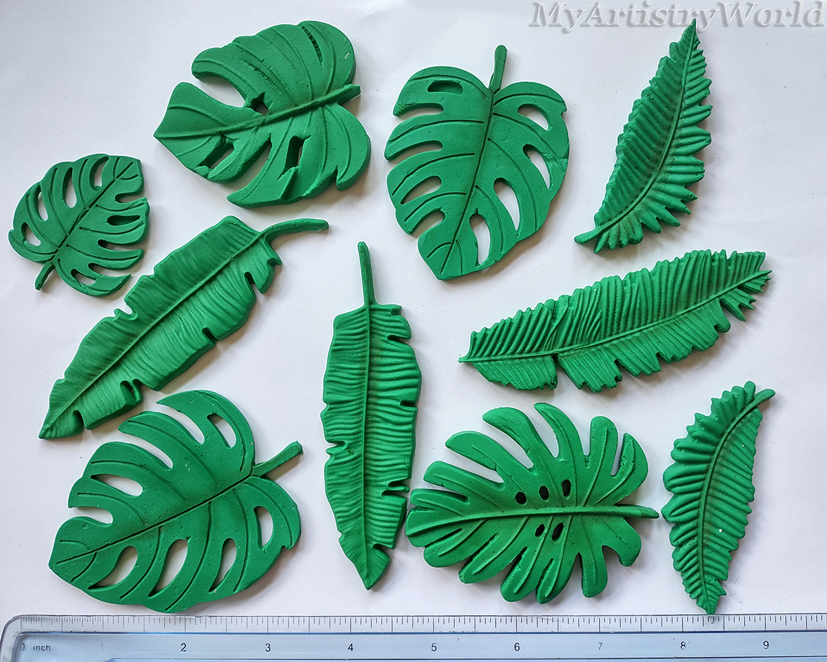 Edible tropical leaf cake toppers — handmade monstera, palm, and banana leaves in green fondant