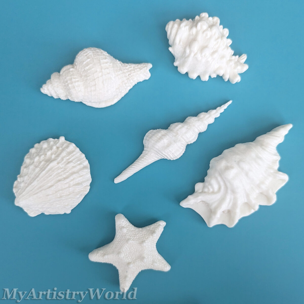 Edible seashell cake toppers with starfish and assorted shell designs
