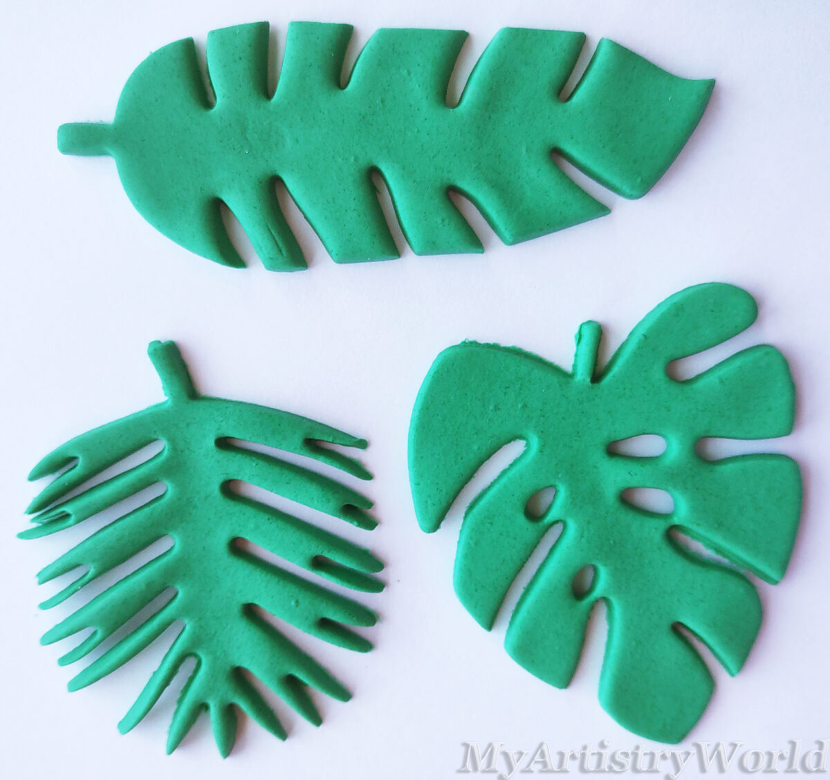 Edible tropical monstera and palm leaf cake toppers for jungle and luau themed cakes and cupcakes.