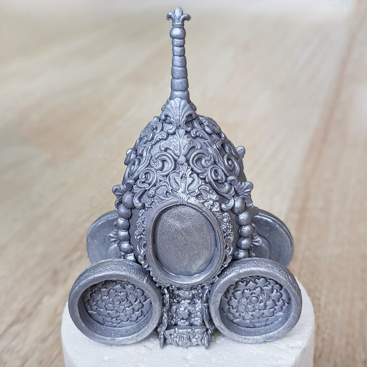 Edible sugar paste silver carriage topper made from gum paste