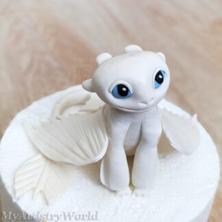 Edible white dragon fondant cake topper with blue eyes and delicate wings handmade by MyArtistryWorld.