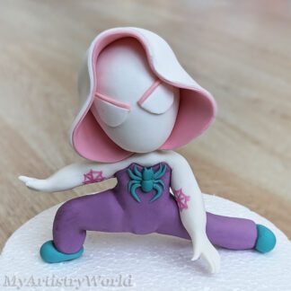 Spider girl fondant cake topper with pink hood and purple outfit on white base