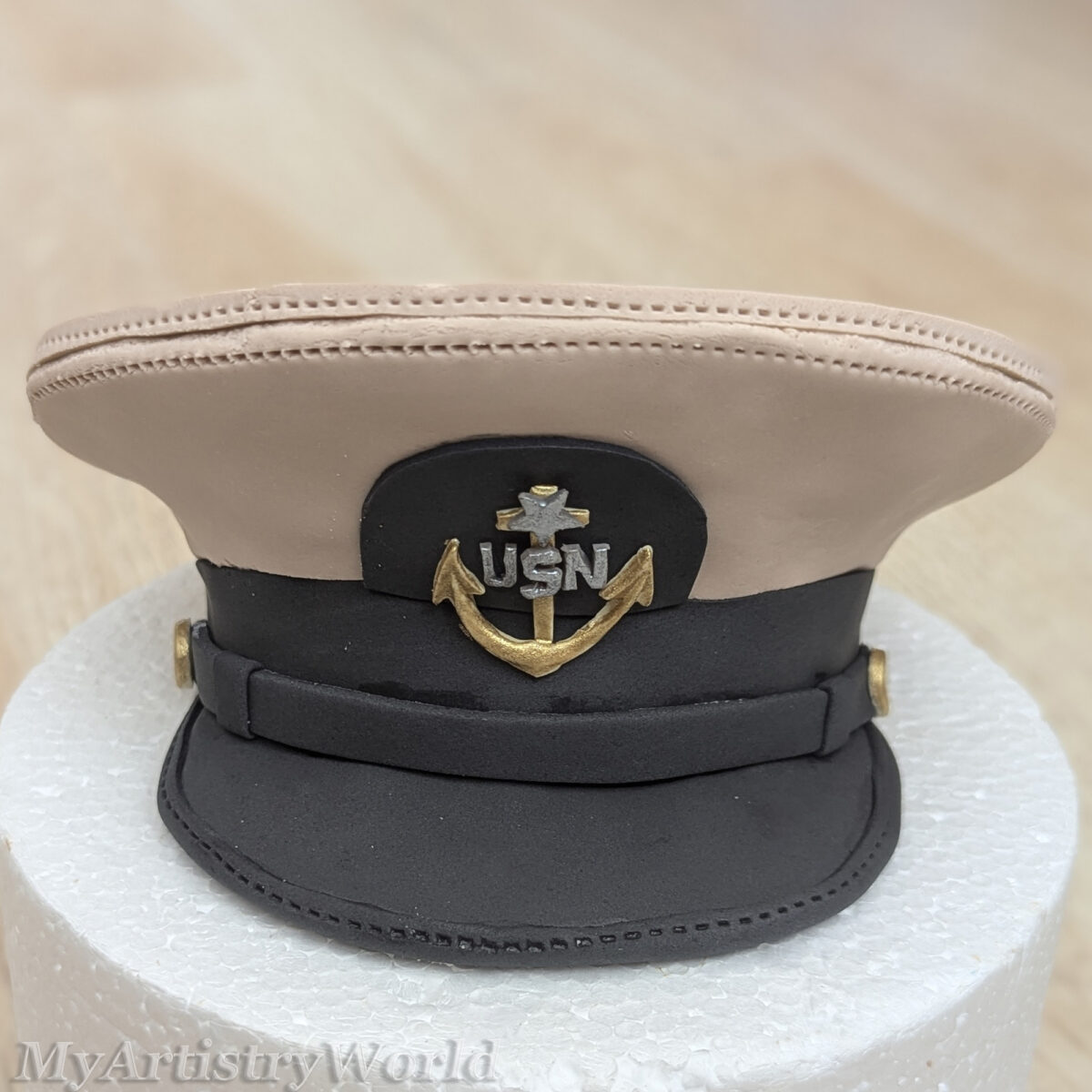 Custom edible Navy captain hat cake topper made from fondant for military retirement, promotion, graduation, and Navy celebration cakes.