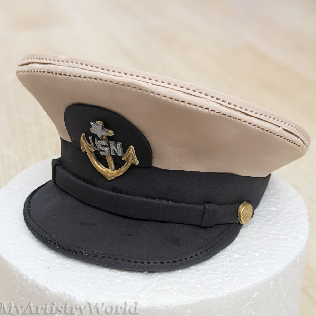 Custom edible Navy captain hat cake topper made from fondant for military retirement, promotion, graduation, and Navy celebration cakes.