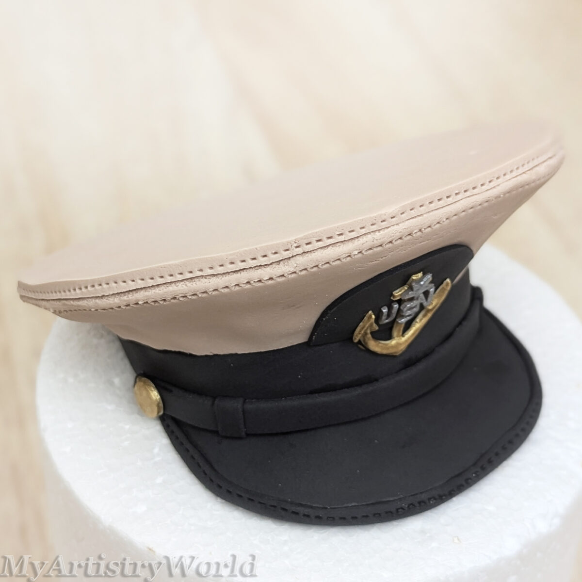Custom edible Navy captain hat cake topper made from fondant for military retirement, promotion, graduation, and Navy celebration cakes.